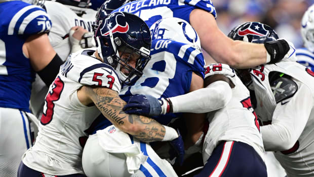 Texans linebacker Blake Cashman grimaces as he helps to tackle Indianapolis Colts running back Jonathan Taylor (28) during the second half at Lucas Oil Stadium.